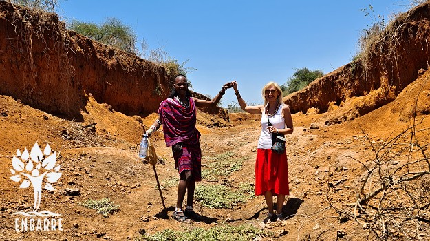 mzungu and masai in a dry water channel