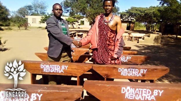 school director in Tanzania with new school benches