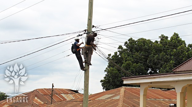 two men repairing wiring in tanzania