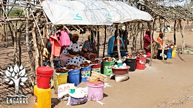 swahili women selling mandazi at market in tanzania